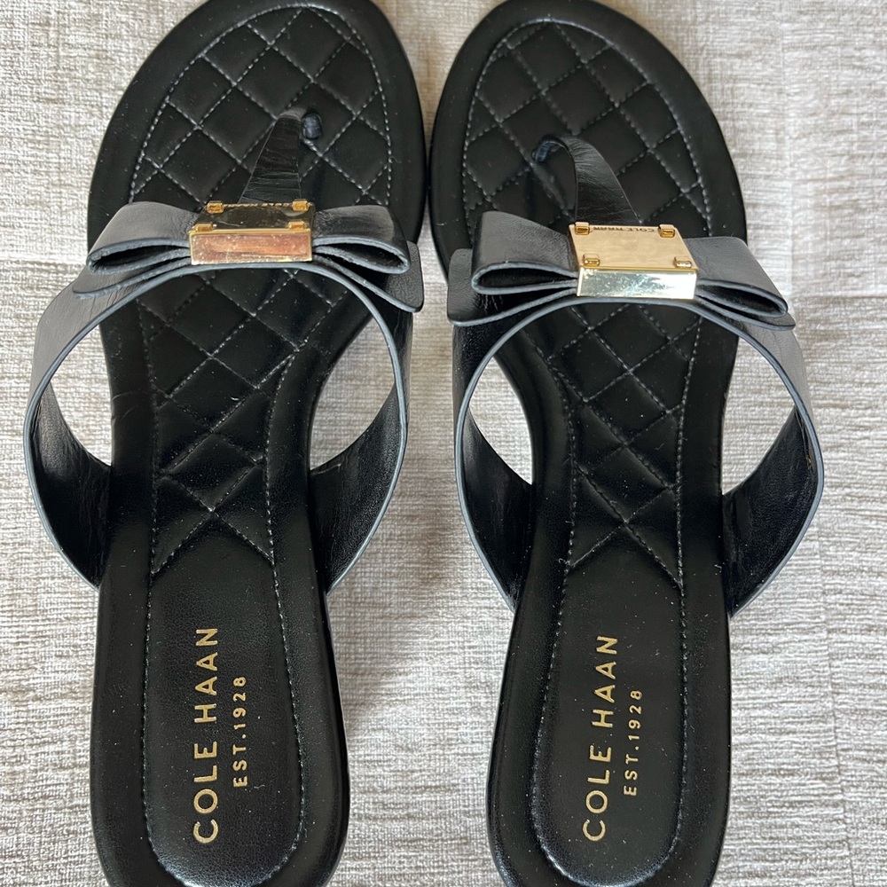 Black sandal by Coke Haan.